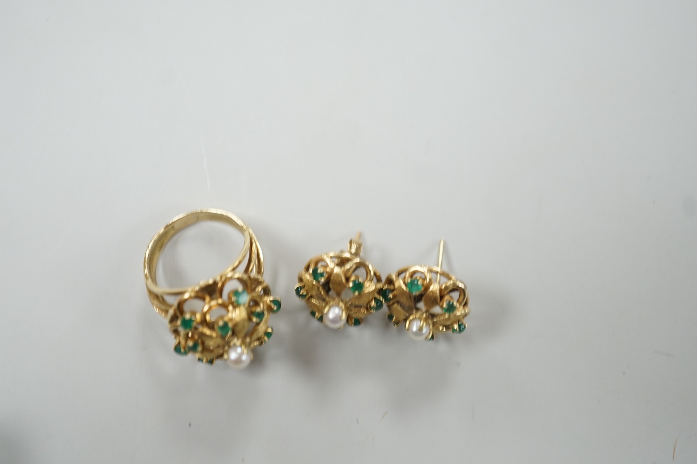 A modern continental, cultured pearl and green stone cluster set dress ring, size N, and a pair of matching earrings, one butterfly missing, gross weight 15 grams.